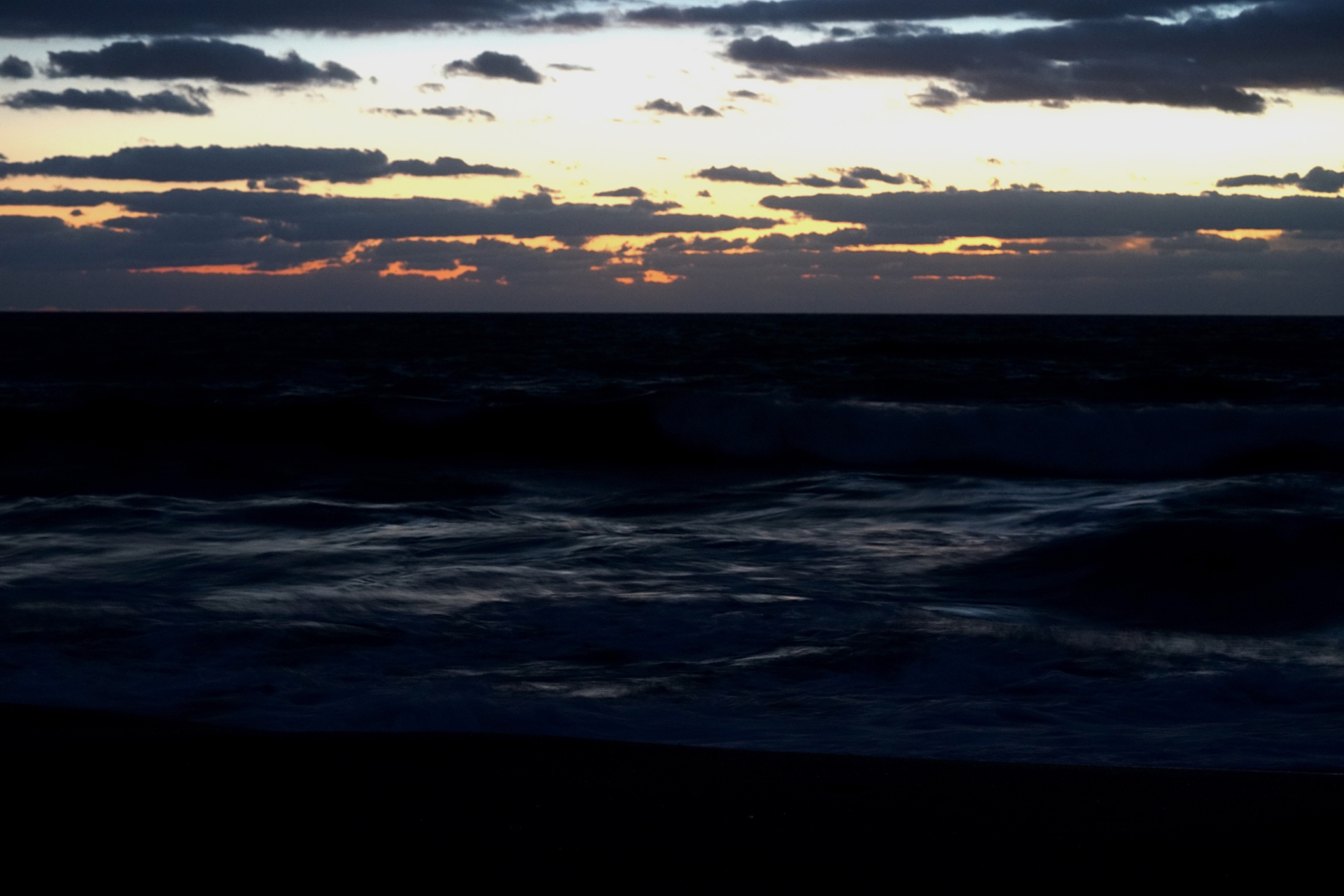 Atlantic Ocean under dark storm clouds at sunset